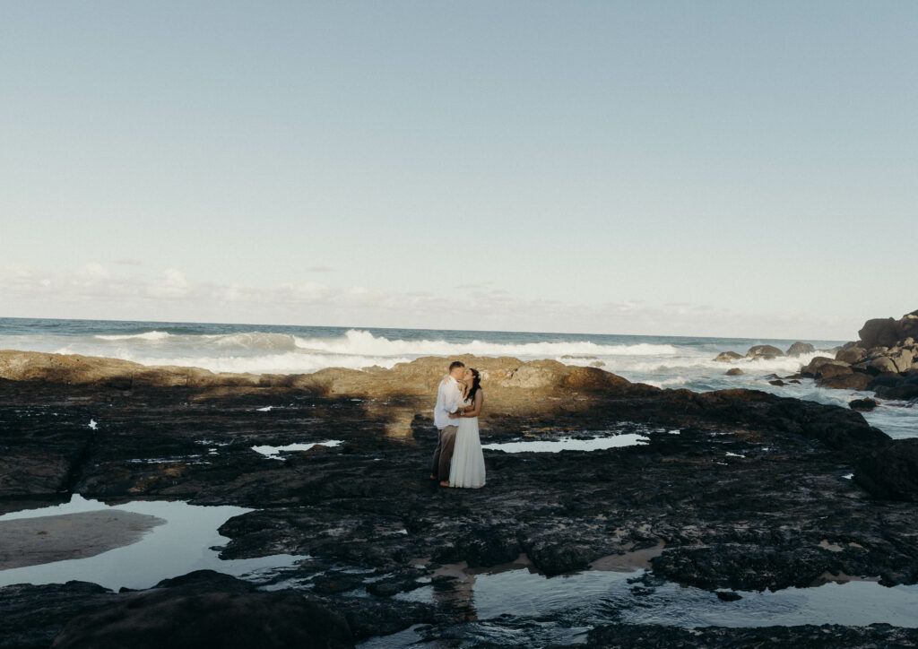 couple beach Coolangatta hugging in front of the sea