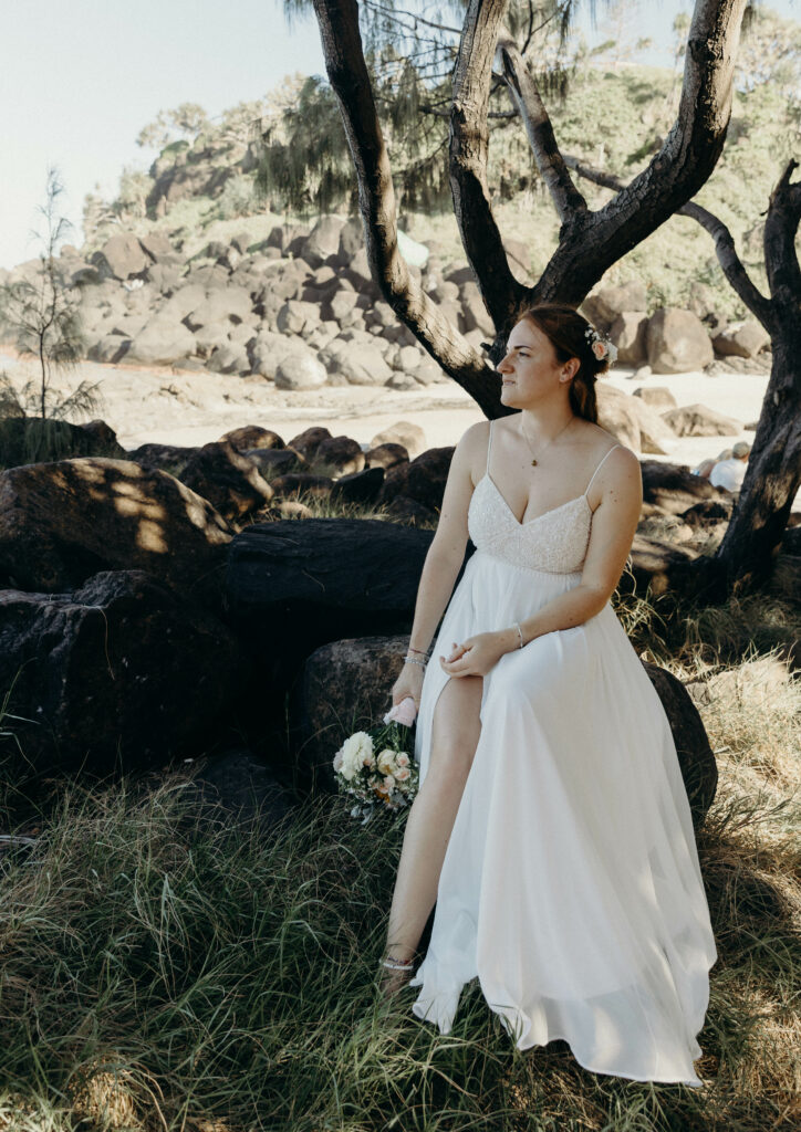 bride rocks sitting sun golden hour
