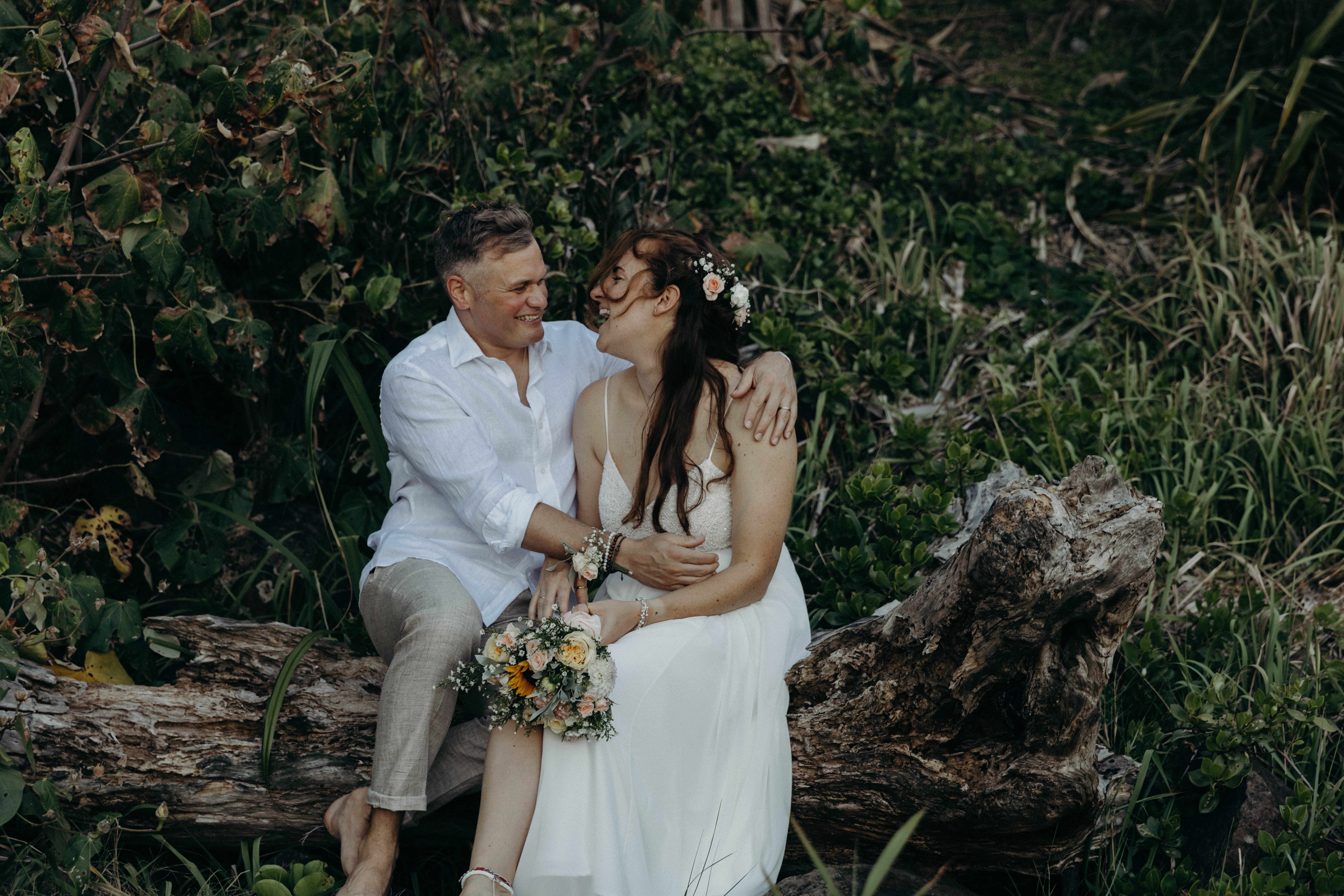 laughing couple bride and groom wedding beach