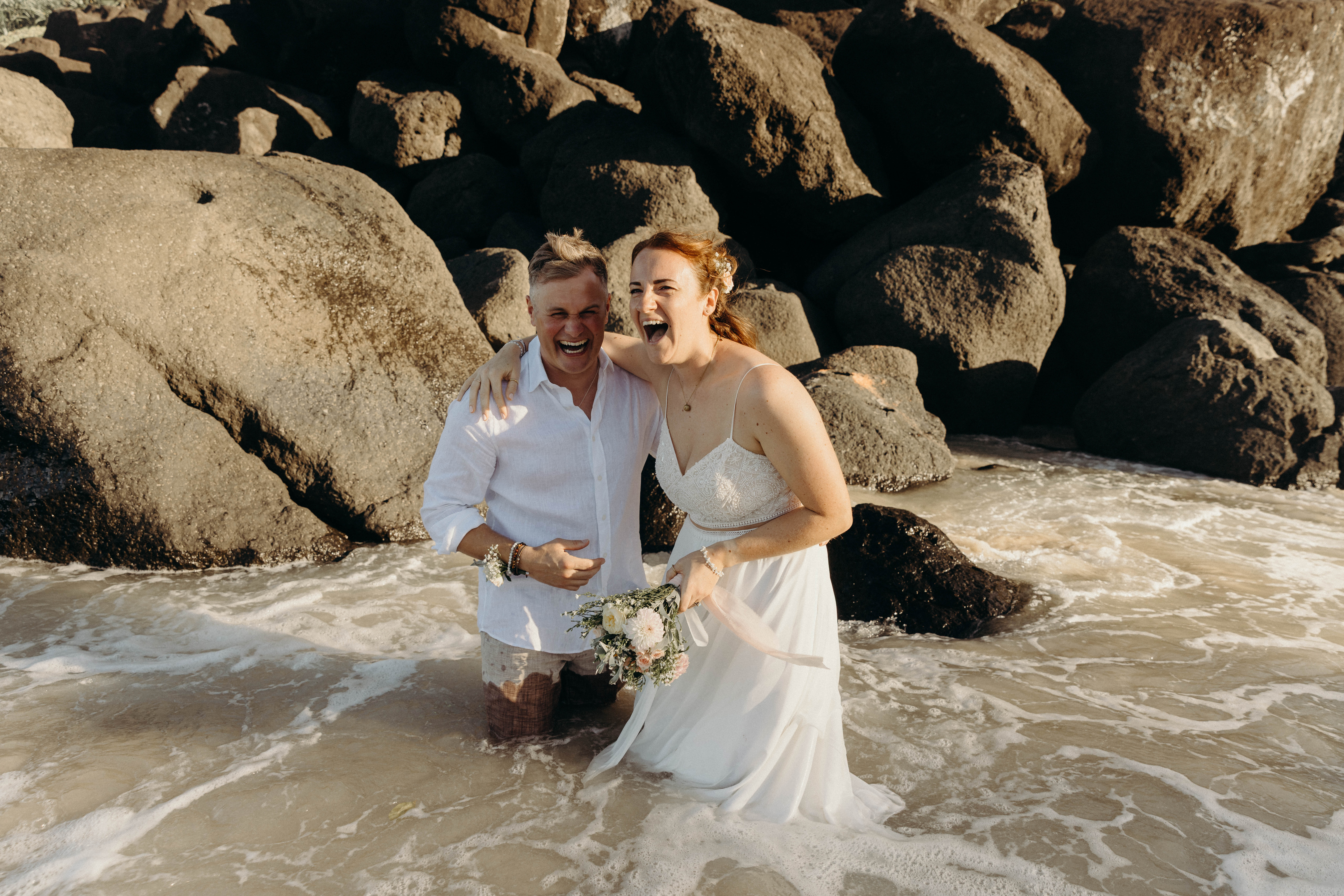 laughing couple bride and groom beach wedding